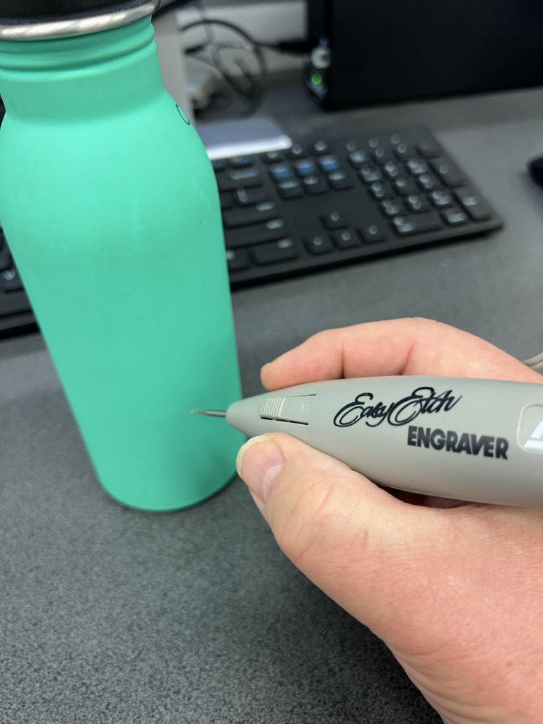 Hand-held engraver in use