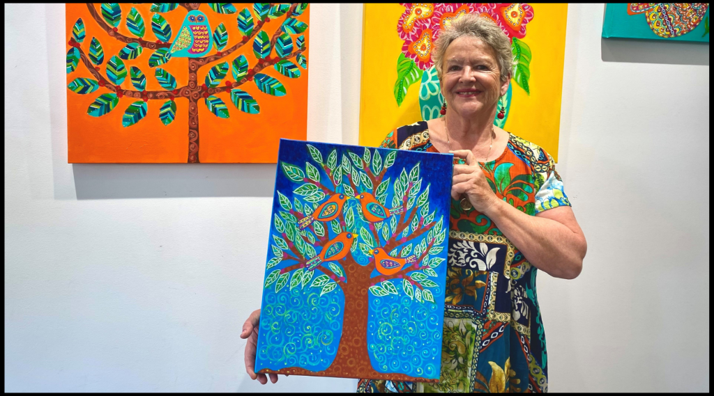 Sally holding her painting Spring Birds